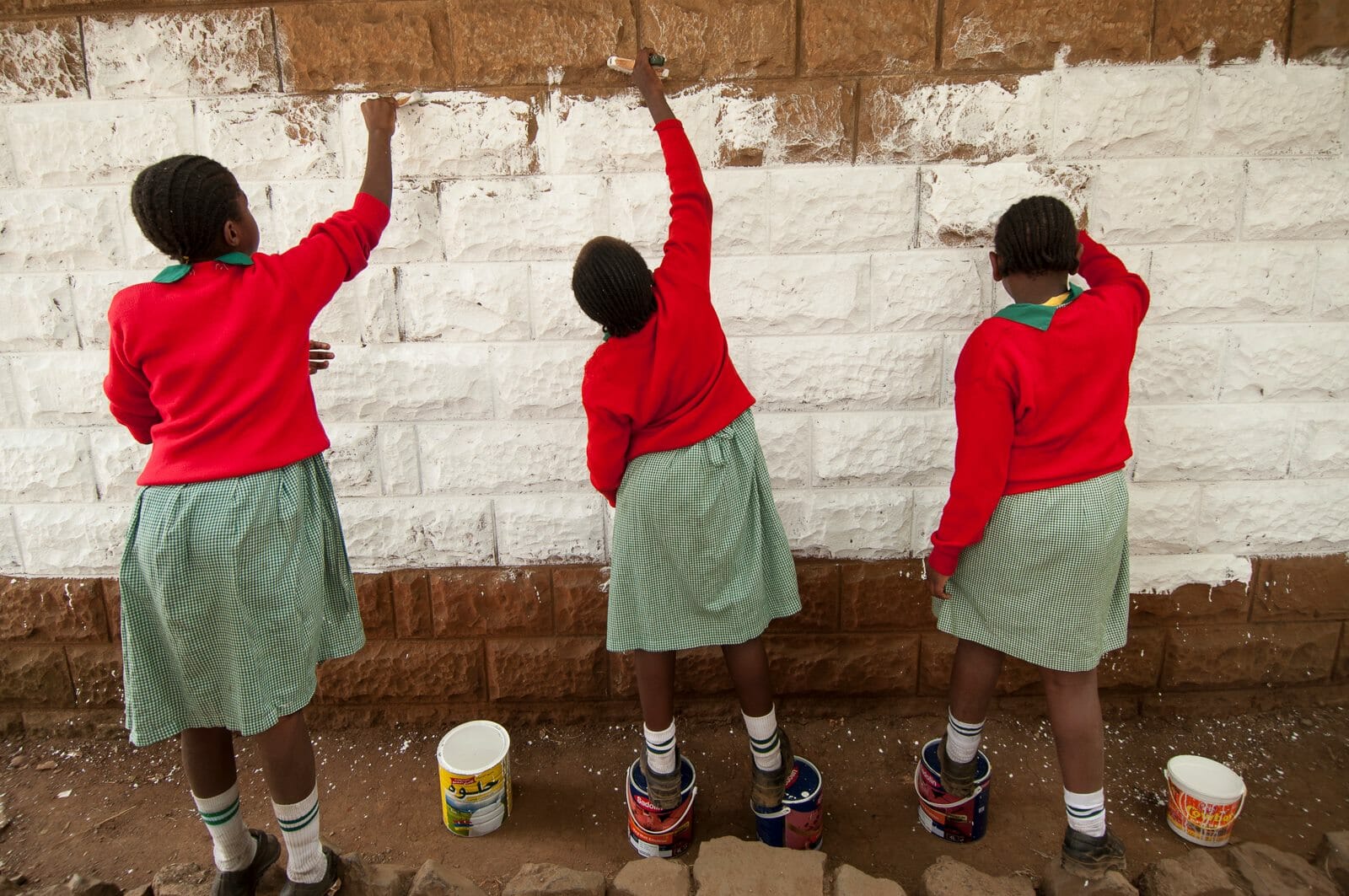 girls painting a wall